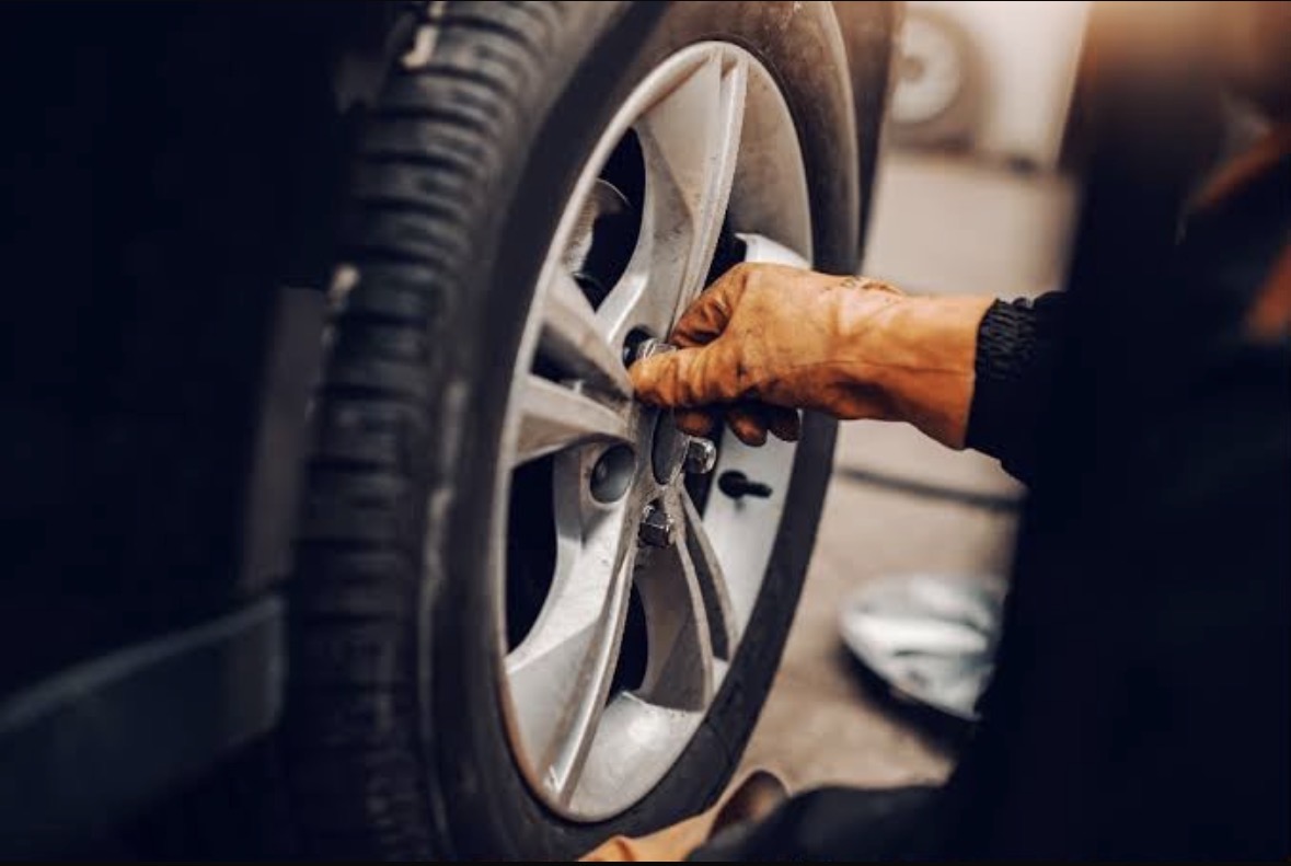 Mechanic fitting tyre at customers location